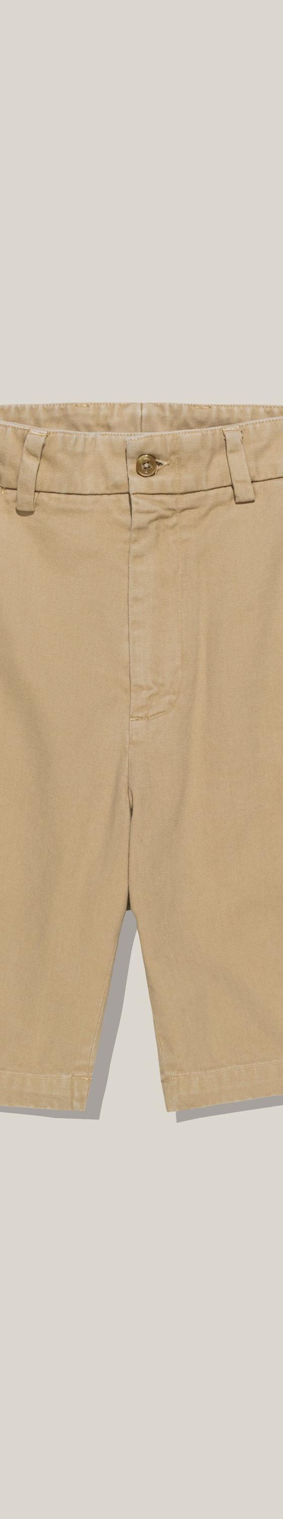 A pair of khaki Bills Khakis cotton twill shorts on a plain background