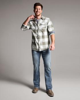 A man wearing a BKE plaid western shirt with light wash bootcut jeans