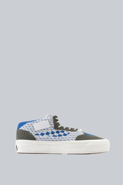 A blue and grey textured Blends mid-top sneaker on a plain grey background