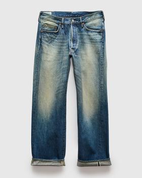 A pair of faded blue selvedge denim jeans with cuffed hems on a plain background