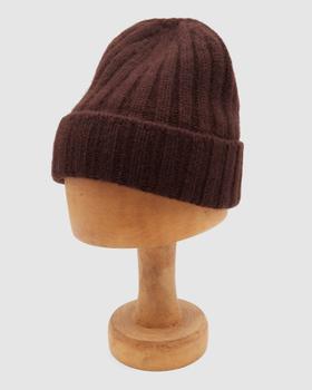 A dark brown ribbed wool Câbleami knit cap displayed on a wooden hat block