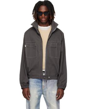 A man wearing a grey CARRER zip blouson with contrast stitching and faded jeans