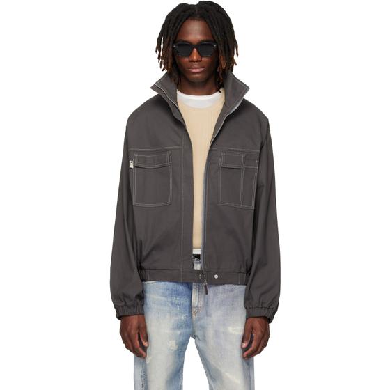 A man wearing a grey CARRER zip blouson with contrast stitching and faded jeans