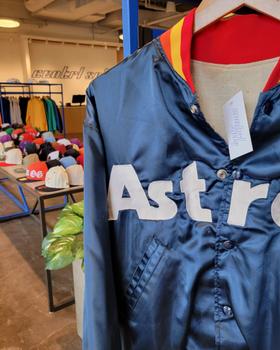 A vintage navy Houston Astros satin jacket displayed on a mannequin inside the Centrl Sply store