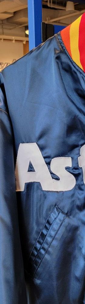 A vintage navy Houston Astros satin jacket displayed on a mannequin inside the Centrl Sply store