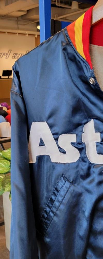 A vintage navy Houston Astros satin jacket displayed on a mannequin inside the Centrl Sply store