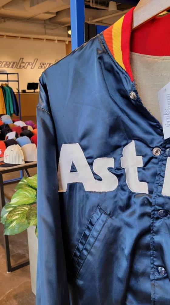 A vintage navy Houston Astros satin jacket displayed on a mannequin inside the Centrl Sply store