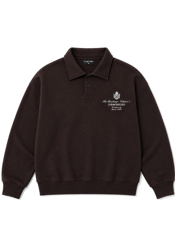 A washed brown Club 1984 collared sweatshirt with embroidered crest on a plain background