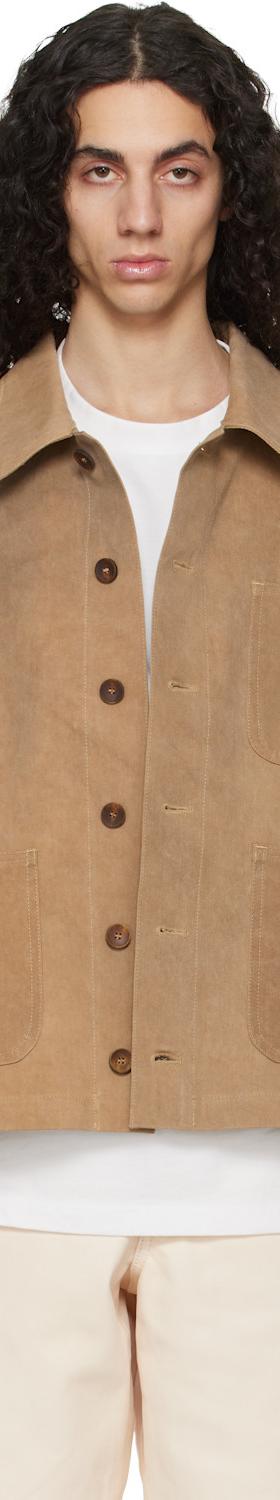 A man wearing a tan suede Colbo jacket over a white tee and cream trousers
