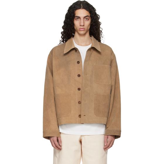 A man wearing a tan suede Colbo jacket over a white tee and cream trousers
