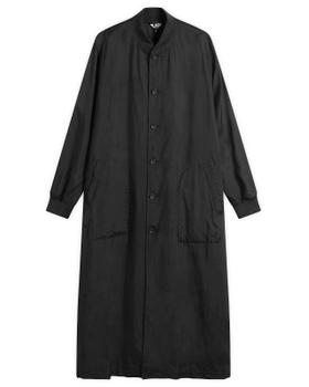 A long black Comme des Garçons Black button-up coat on a plain white background