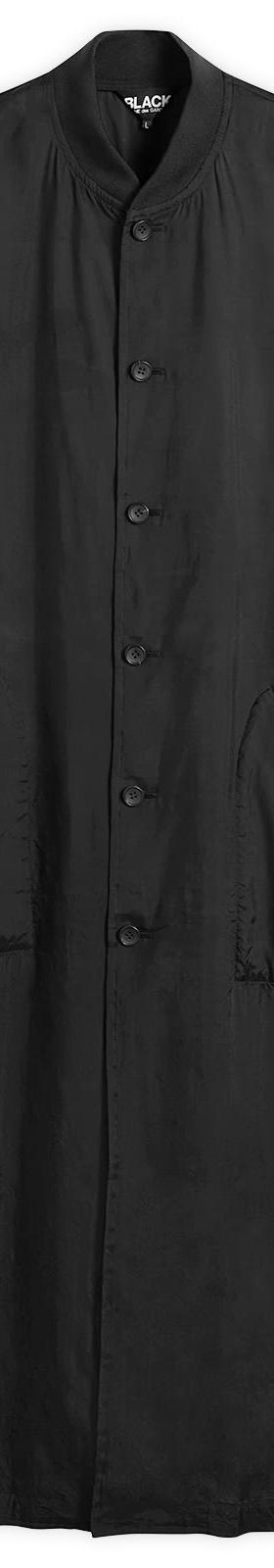 A long black Comme des Garçons Black button-up coat on a plain white background
