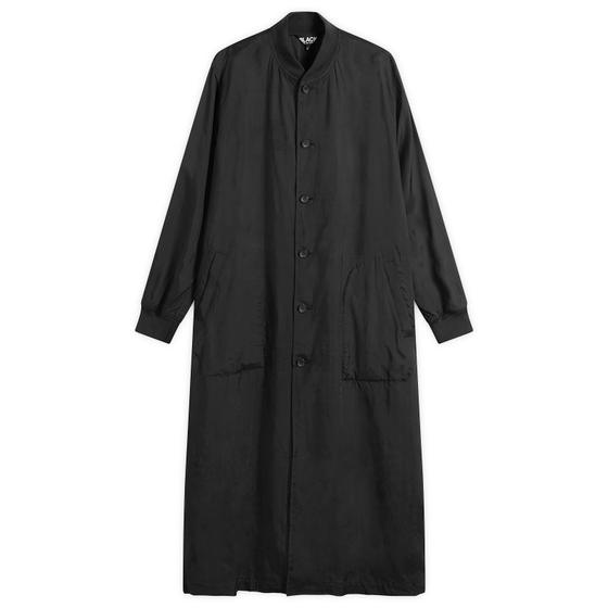 A long black Comme des Garçons Black button-up coat on a plain white background