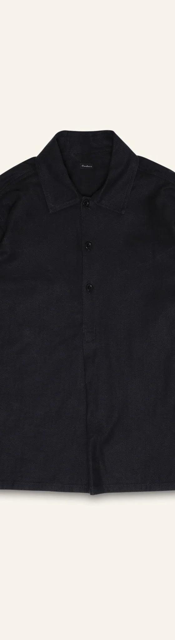 A black linen-cotton Conkers overshirt photographed flat on a cream background