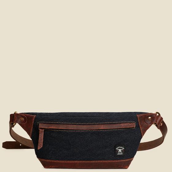 A Craft & Glory denim and leather sling waist bag on a plain cream background