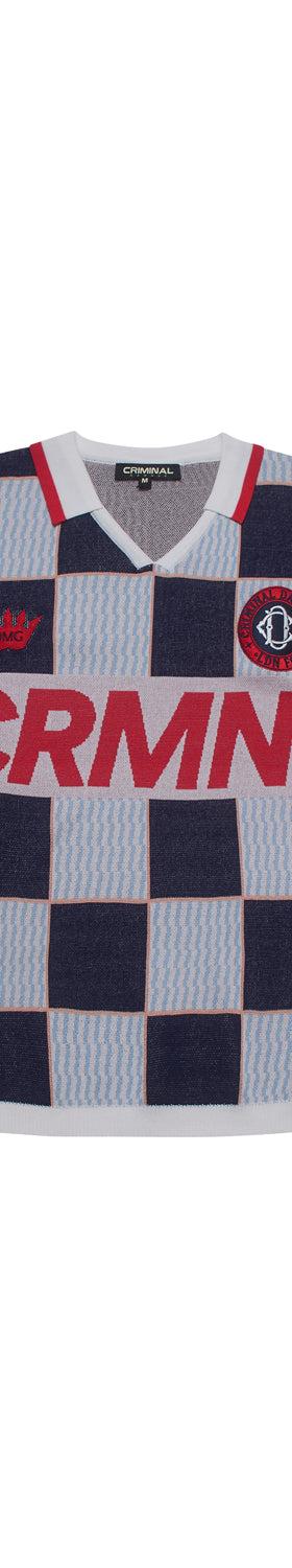 A navy and light blue checkerboard Criminal Damage knitted football shirt on a plain white background