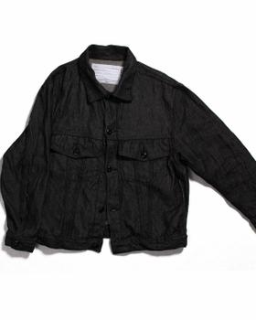 A black naturally dyed Dana Lee denim jacket on a plain white background