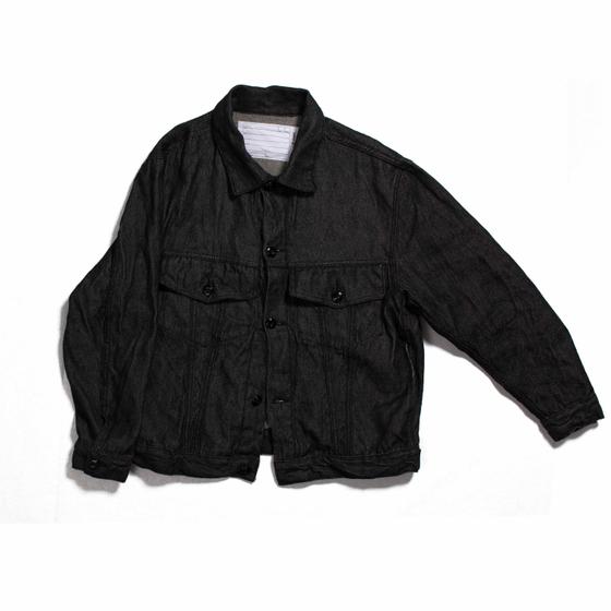 A black naturally dyed Dana Lee denim jacket on a plain white background