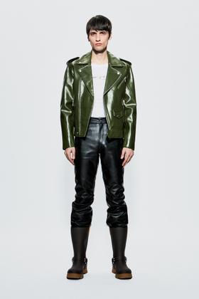 A model wearing a green Deadwood leather biker jacket with black leather trousers and boots