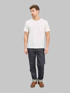 A man wearing raw selvedge Denime jeans with a white pocket T-shirt