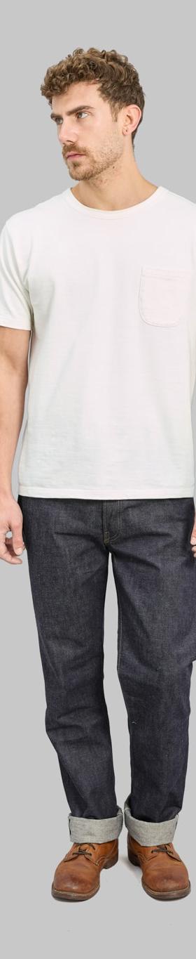 A man wearing raw selvedge Denime jeans with a white pocket T-shirt