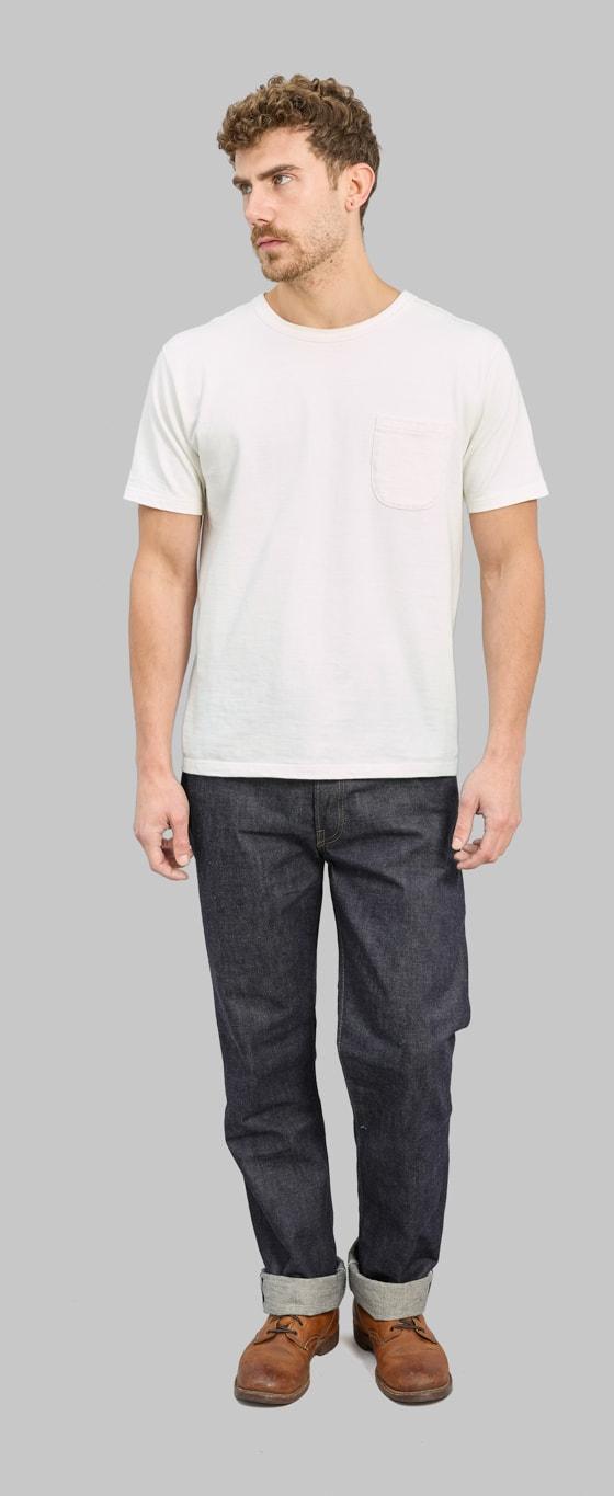 A man wearing raw selvedge Denime jeans with a white pocket T-shirt