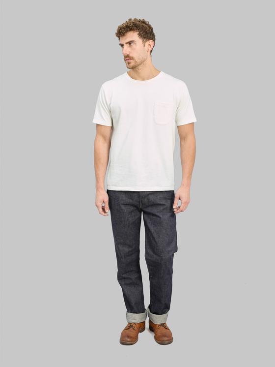 A man wearing raw selvedge Denime jeans with a white pocket T-shirt