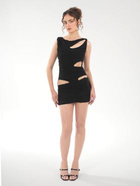 A woman wearing a black draped Di Petsa mini dress with cut-outs