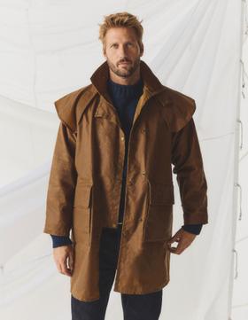 A man wearing a sandstone Driza-Bone Ranger oilskin riding coat