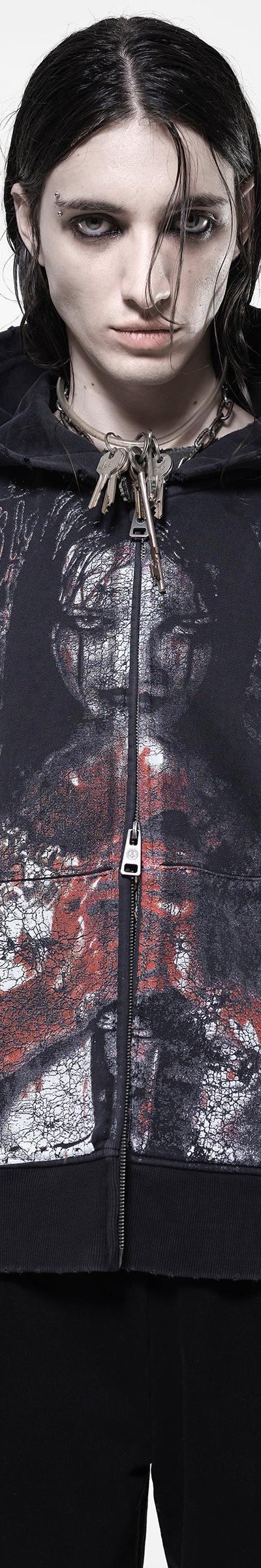 A model wearing an oversized black zip-up hoodie with a distressed horror print by Drop Dead Clothing