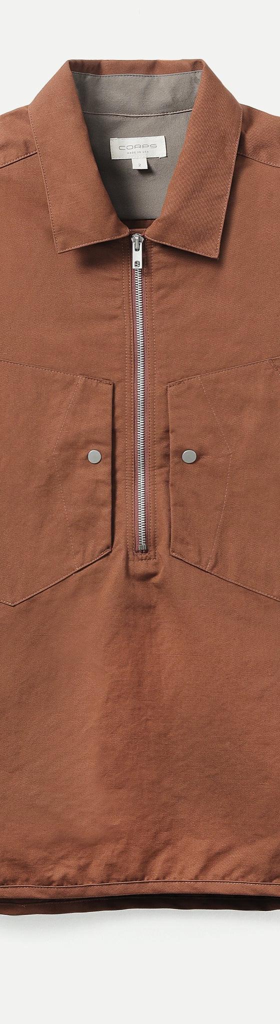 A brown half-zip short sleeve utility shirt with chest pockets