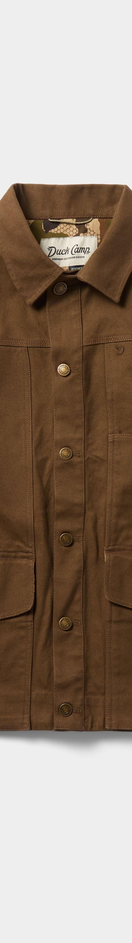 A brown waxed canvas Duck Camp chore jacket on a plain background