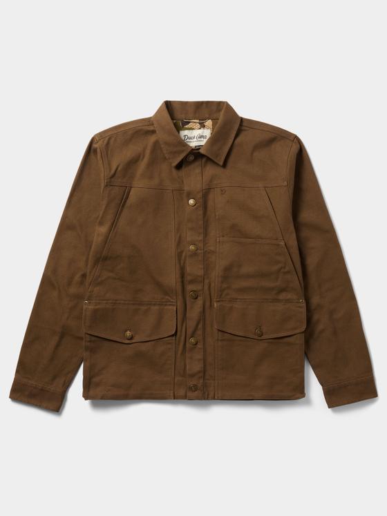 A brown waxed canvas Duck Camp chore jacket on a plain background