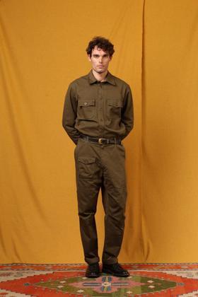 A man wearing an olive East Harbour Surplus military shirt and cargo trousers