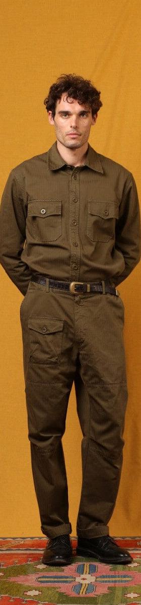 A man wearing an olive East Harbour Surplus military shirt and cargo trousers