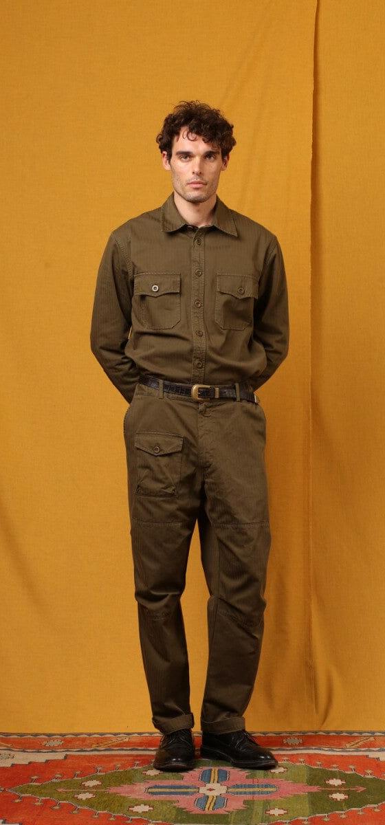 A man wearing an olive East Harbour Surplus military shirt and cargo trousers