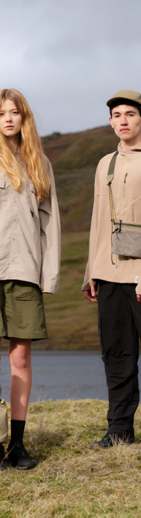 Two models in the hills, one carrying an olive Elliker tote bag and the other a beige crossbody pouch