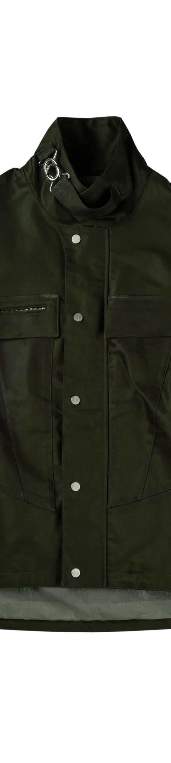 A dark olive FFFPOSTALSERVICE paneled technical jacket with contrast green side inserts and snap front