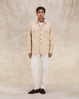 A man wearing a cream Fortela corduroy overshirt with off-white trousers