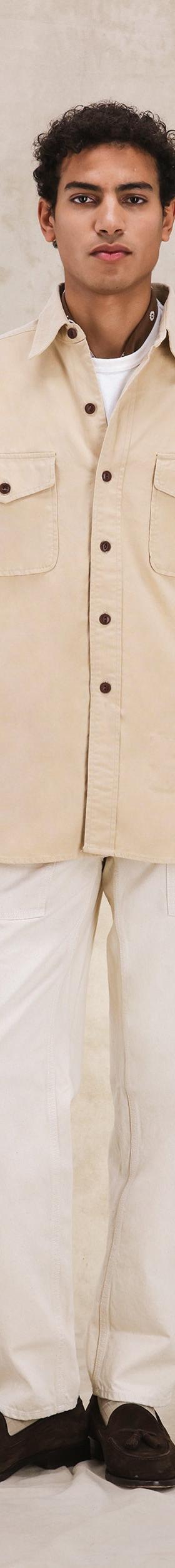 A man wearing a cream Fortela corduroy overshirt with off-white trousers
