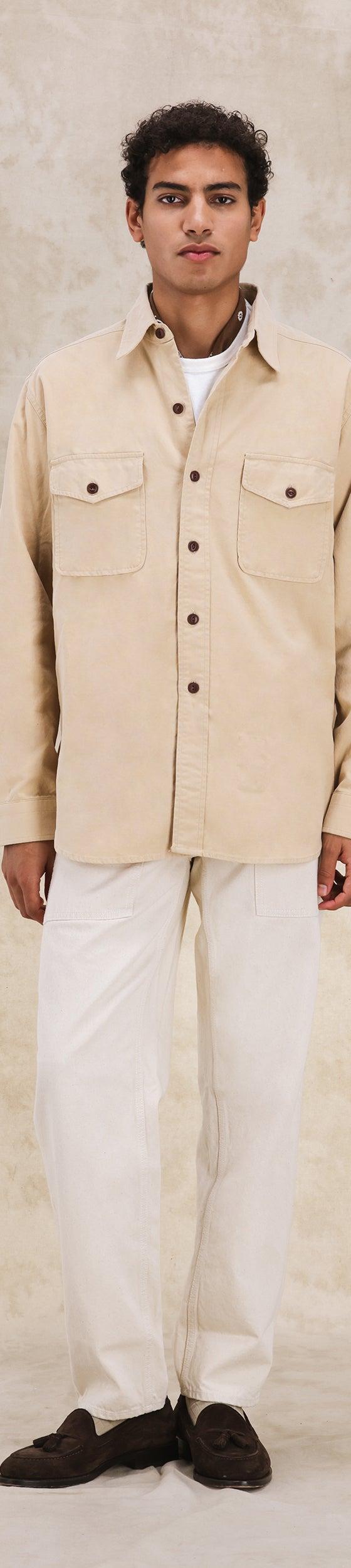 A man wearing a cream Fortela corduroy overshirt with off-white trousers