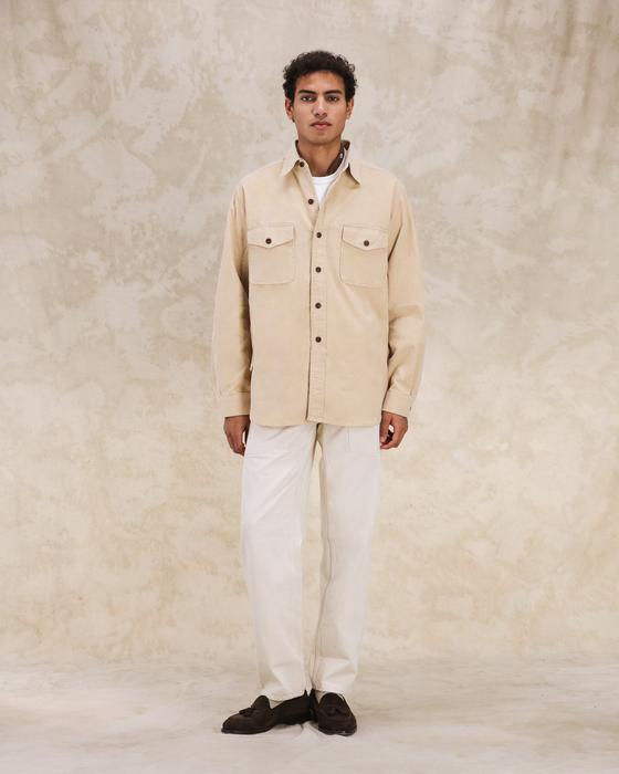 A man wearing a cream Fortela corduroy overshirt with off-white trousers