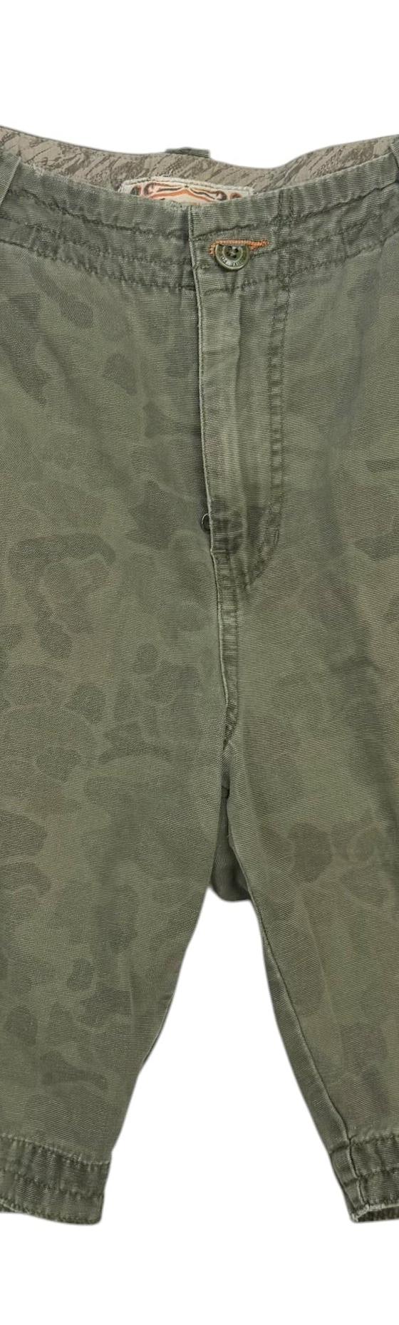 A pair of vintage olive camo cargo shorts on a plain white background