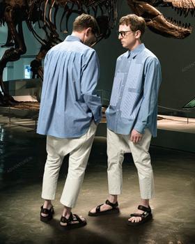 Two men wearing Fumito Ganryu blue striped panelled shirts with cropped cream trousers and sport sandals