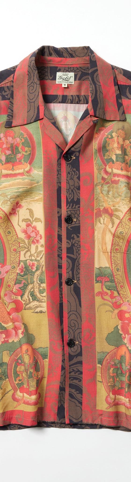 A gold (Toyo Enterprise) open-collar rayon aloha shirt in a red, green and gold vintage-inspired print