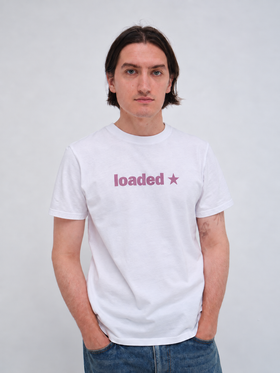 A man wearing a white Hanover t-shirt with jeans