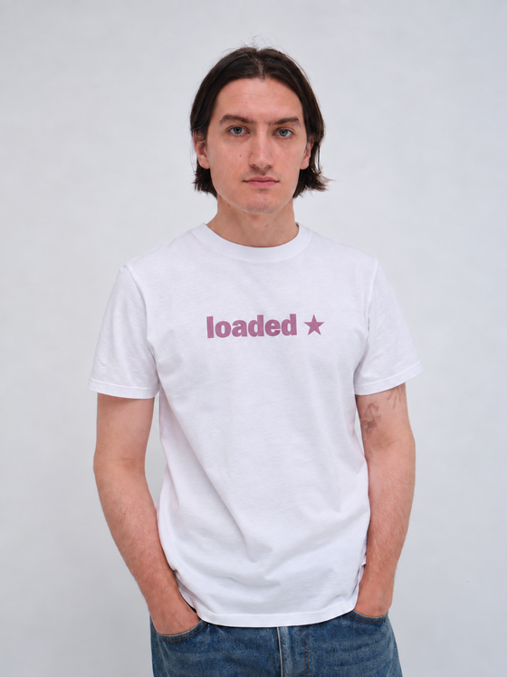 A man wearing a white Hanover t-shirt with jeans