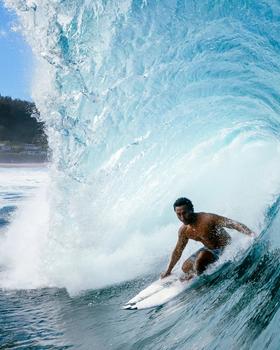 Hawaiian Island Creations surfer riding inside a barrelling wave
