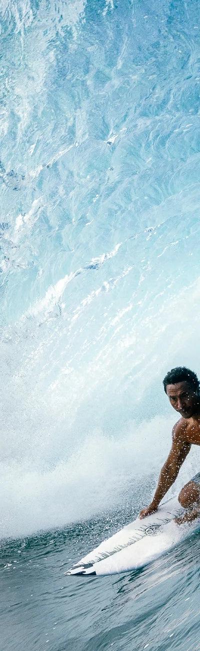 Hawaiian Island Creations surfer riding inside a barrelling wave
