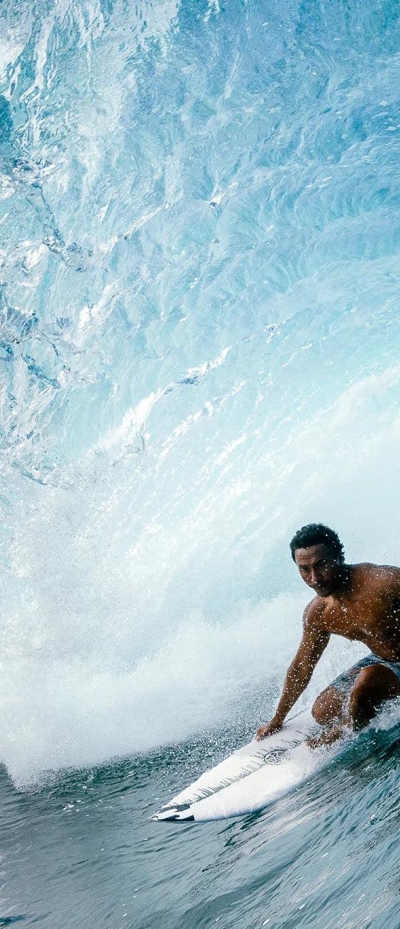 Hawaiian Island Creations surfer riding inside a barrelling wave